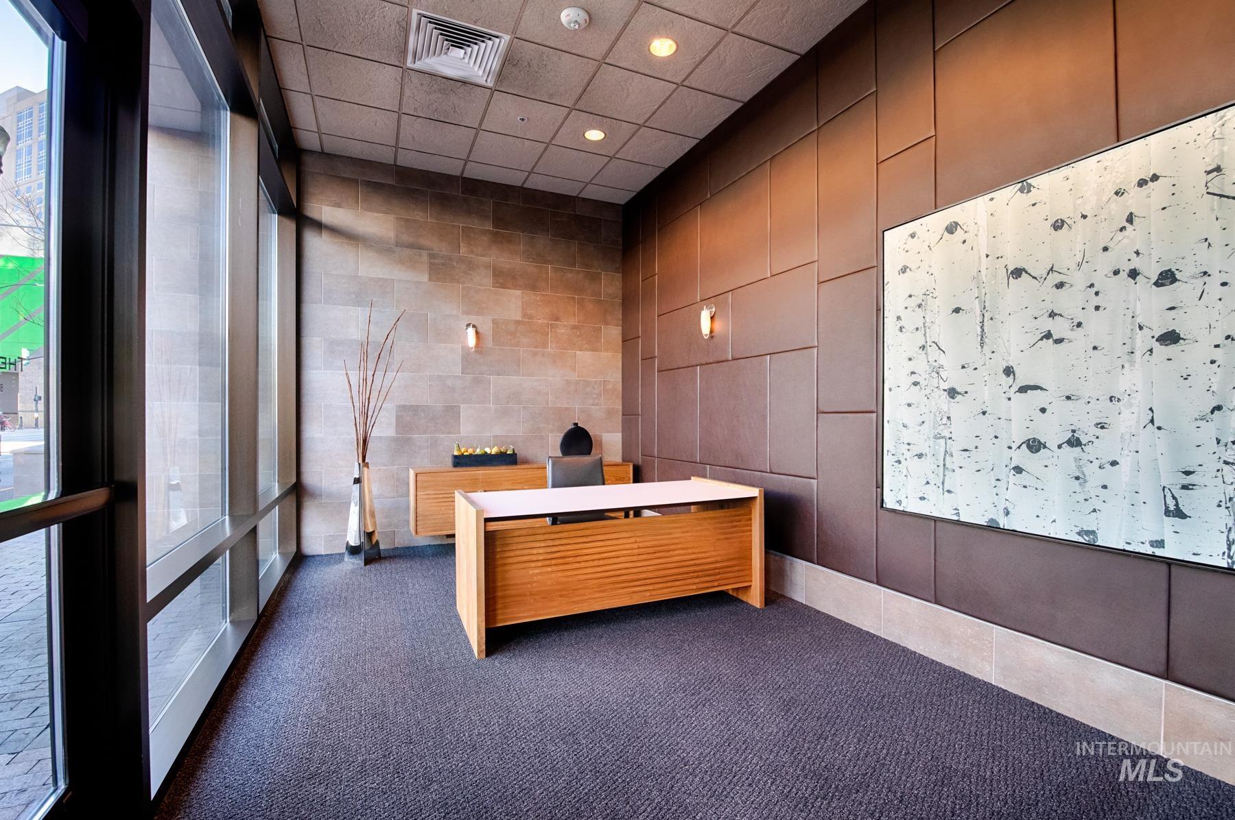 Reception featuring recessed lighting, a paneled ceiling, and tile walls