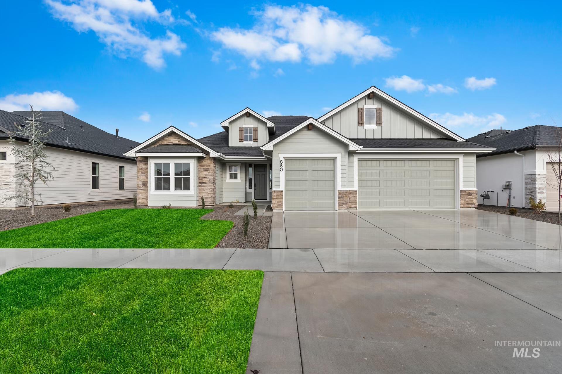 Craftsman-style home with a front lawn, board and batten siding, concrete driveway, roof with shingles, and an attached garage