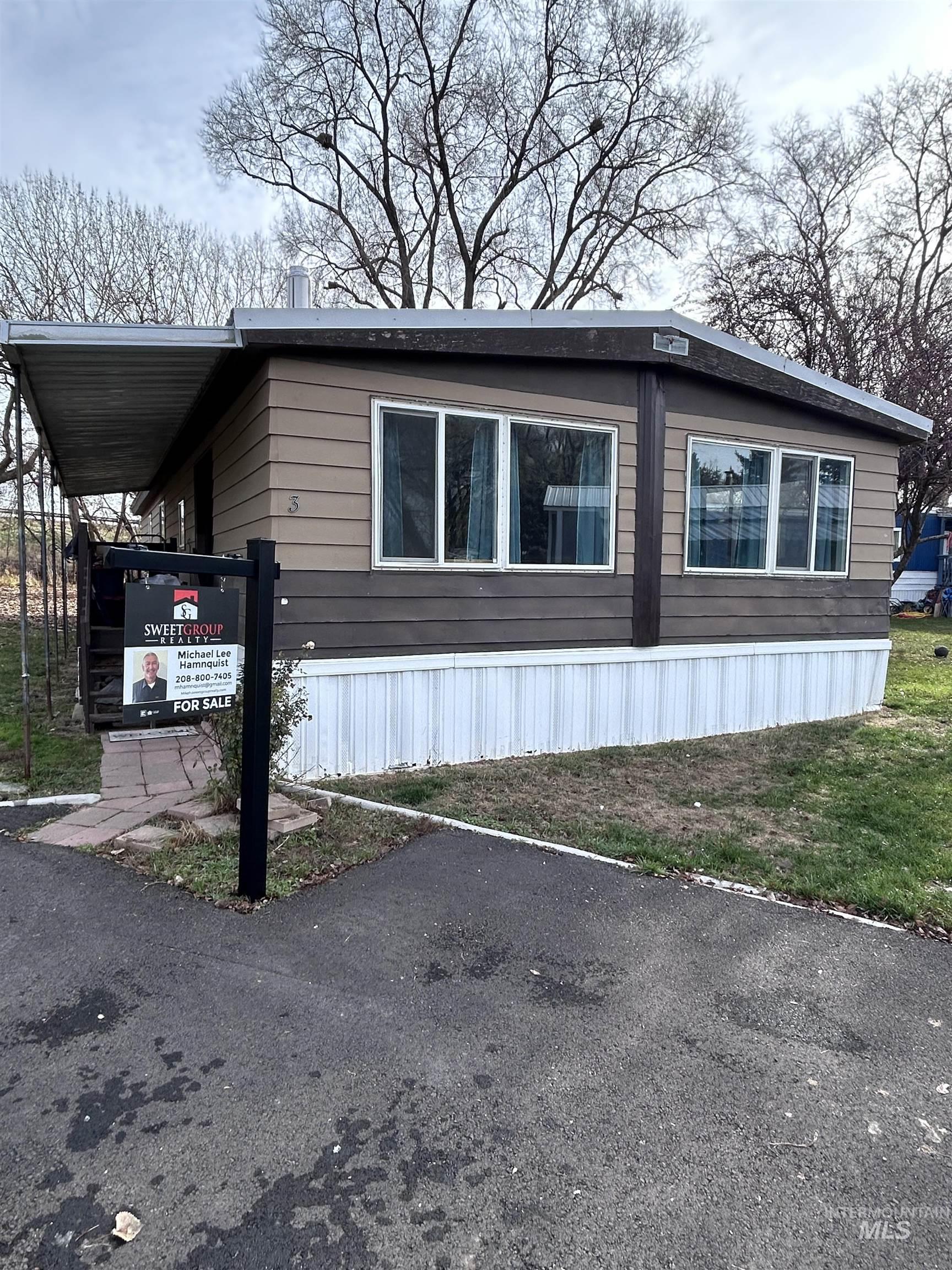 View of side of property with a lawn