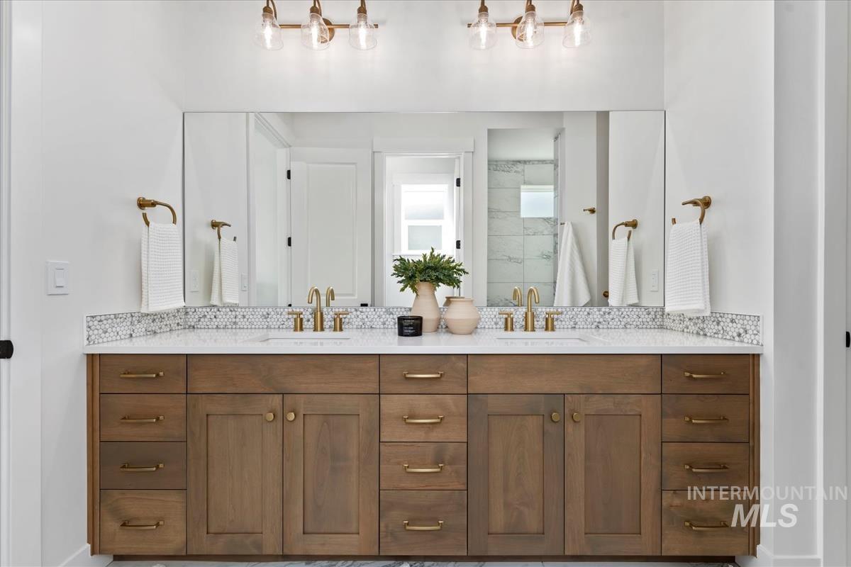 Bathroom with double vanity and a stall shower