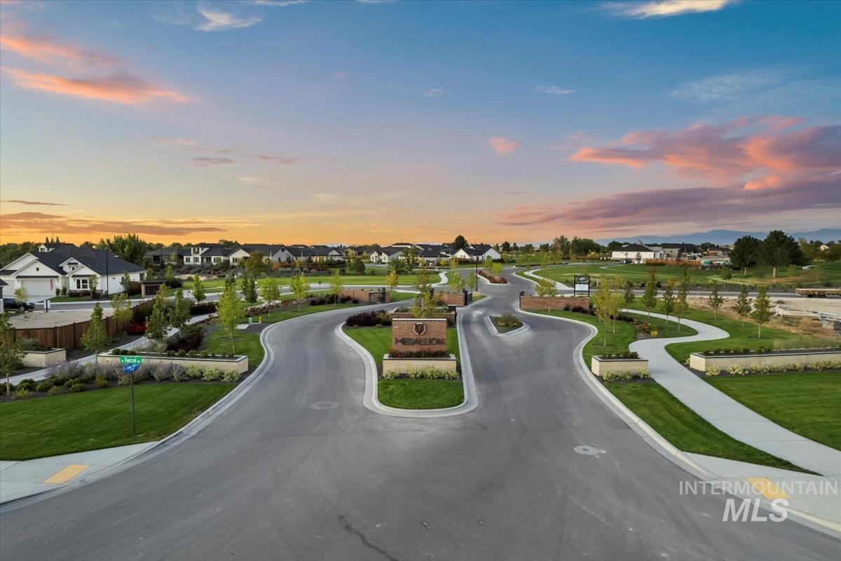 View of asphalt street with curbs, sidewalks, and a residential view