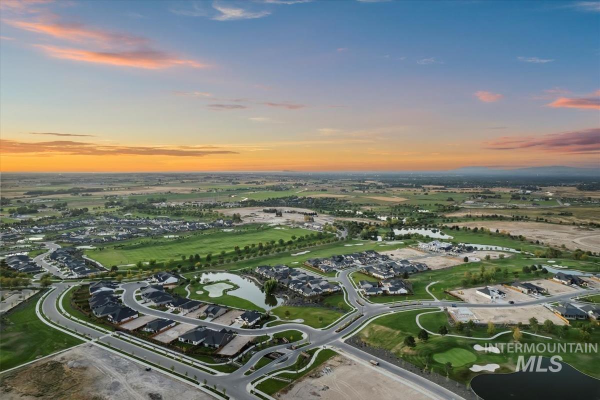 Aerial view at dusk of a water view and golf course view
