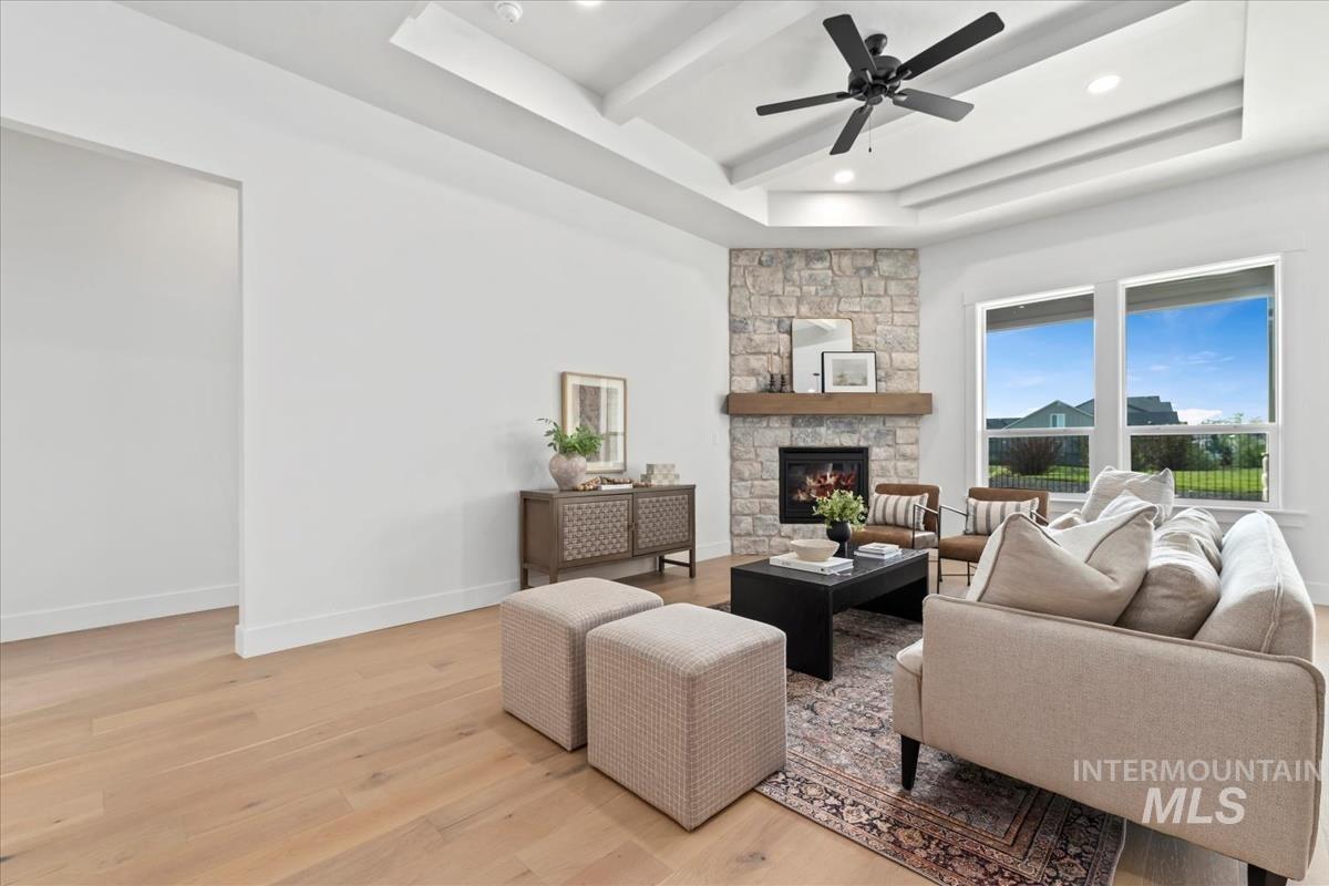 Living room with light wood finished floors, a fireplace, recessed lighting, and a ceiling fan