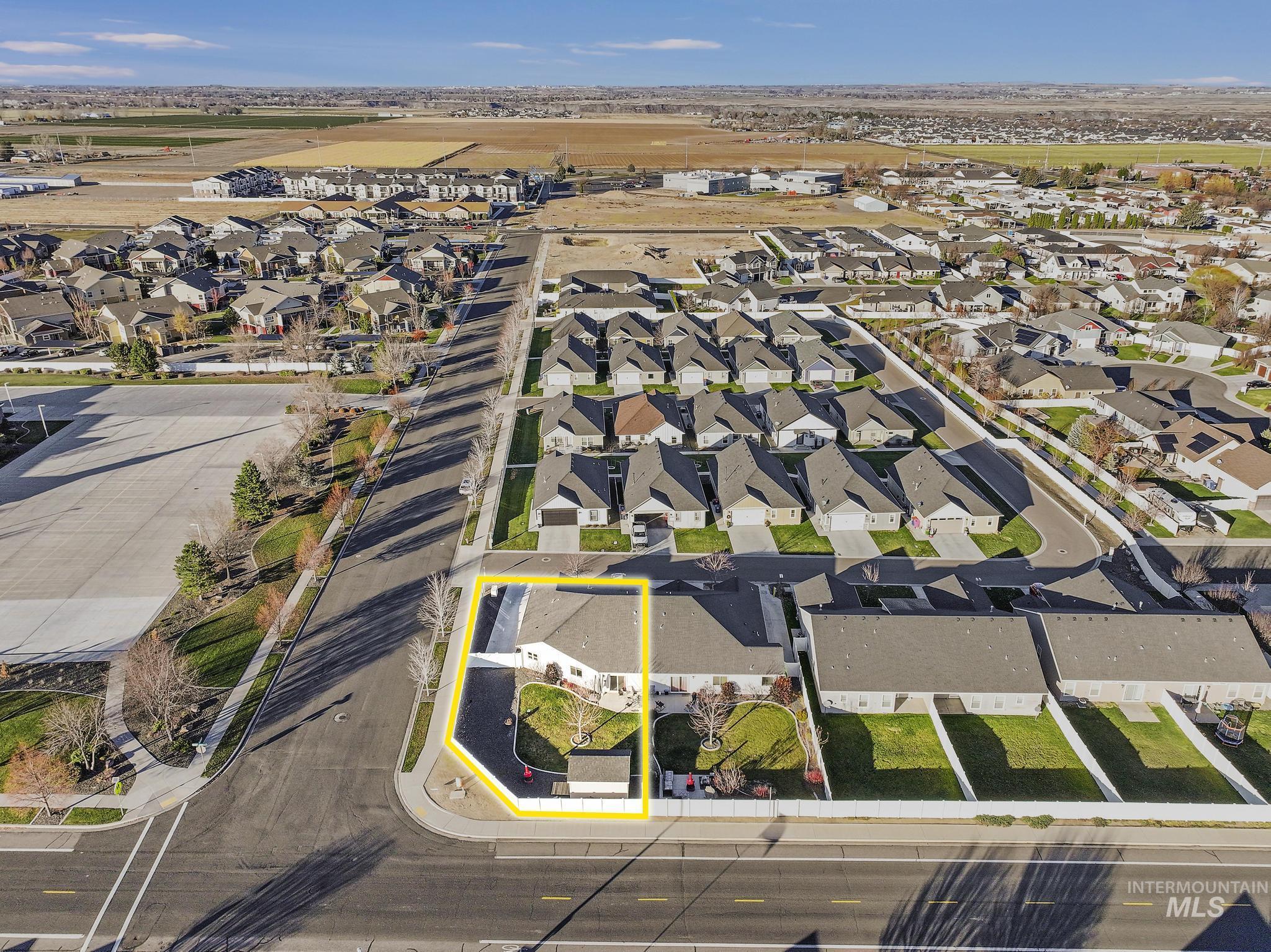 Aerial view of property and surrounding area with nearby suburban area