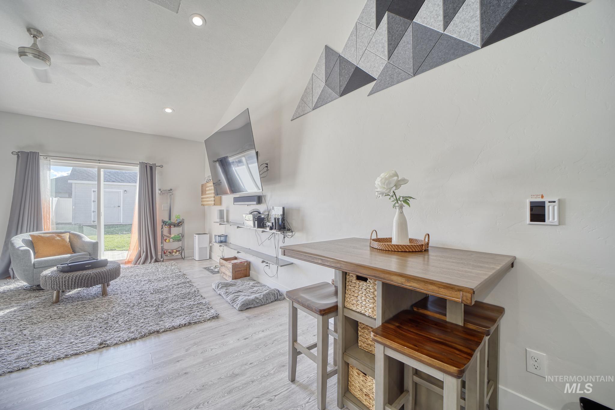 Dining area featuring light wood-style floors, recessed lighting, and a ceiling fan