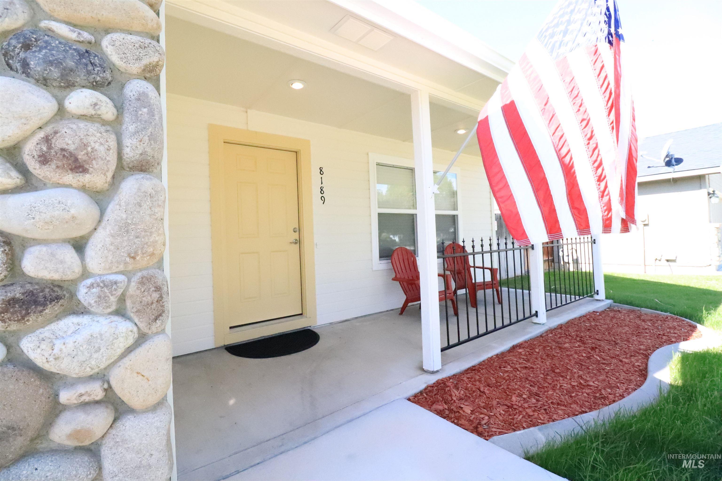 View of exterior entry featuring covered porch