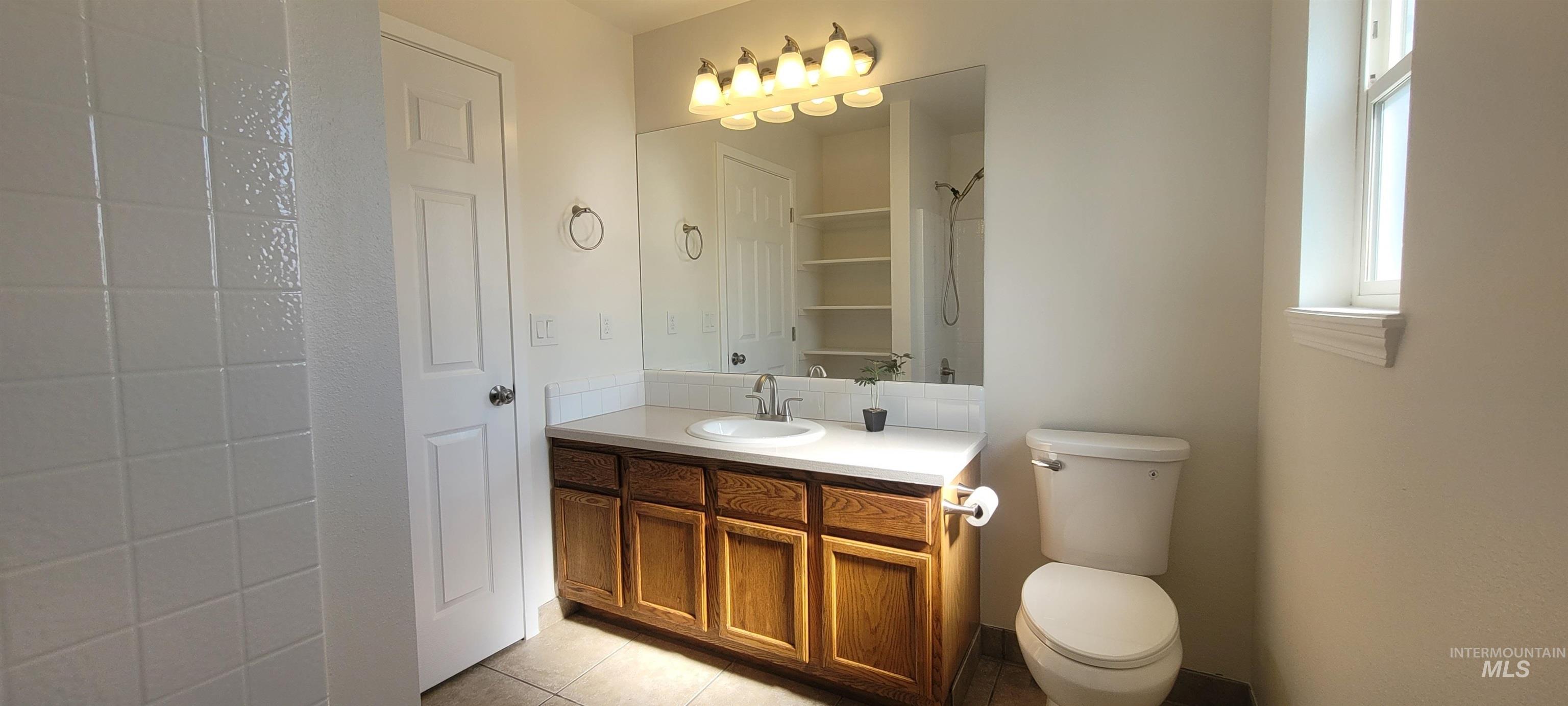 Bathroom with vanity and tile patterned flooring