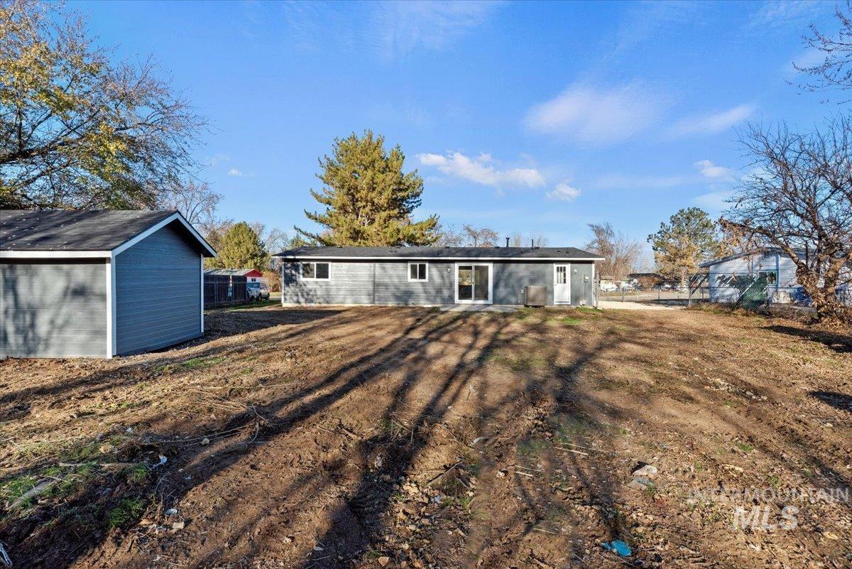 Rear view of house featuring an outdoor structure