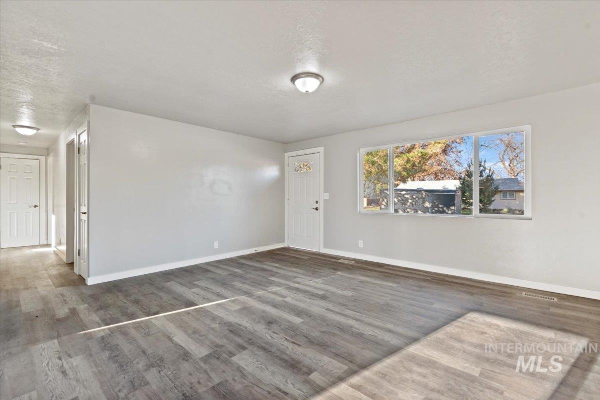 Spare room with a textured ceiling and wood finished floors