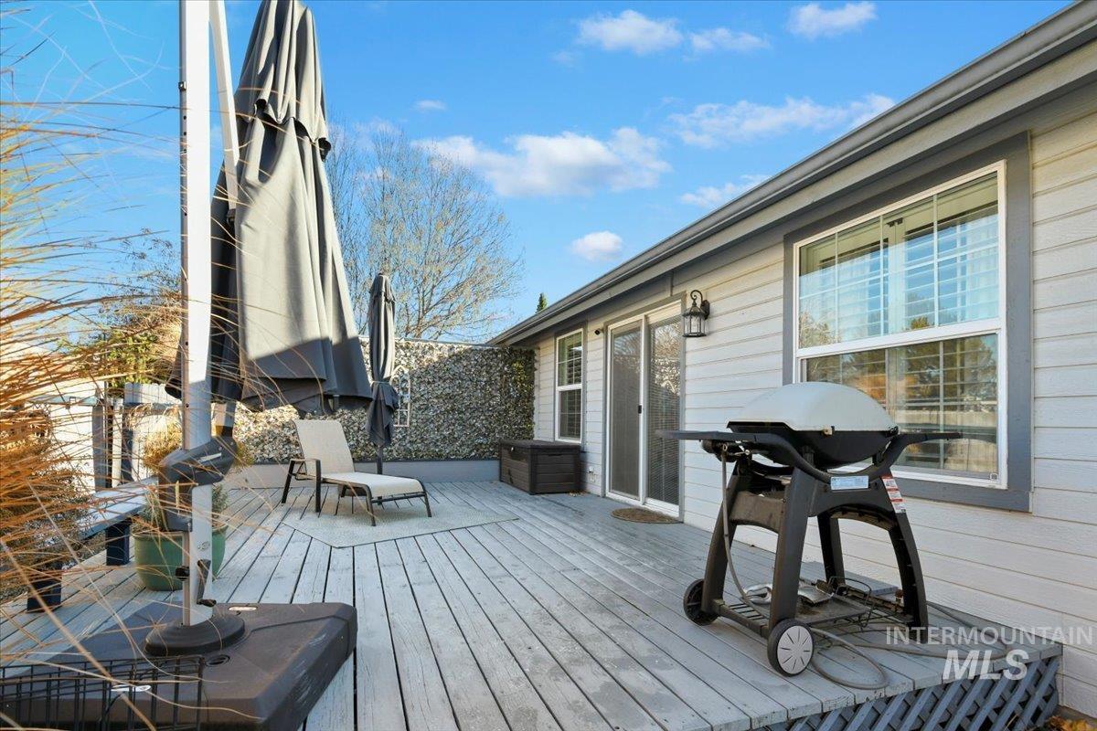 Wooden terrace featuring grilling area