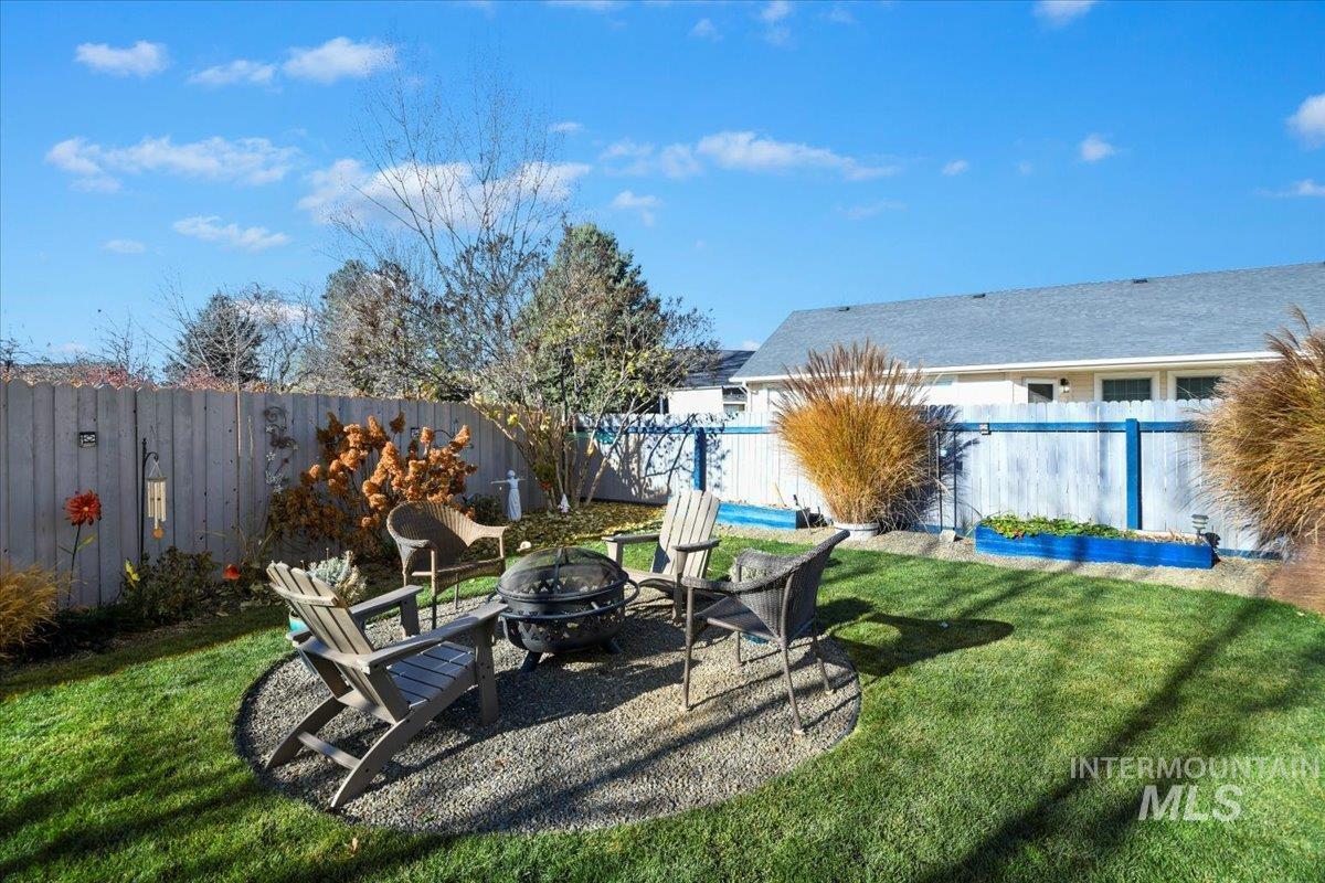 Fenced backyard featuring a patio and an outdoor fire pit