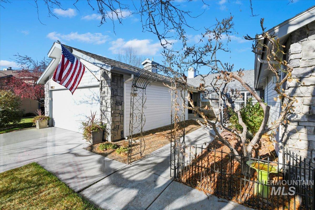 View of home's exterior featuring driveway, a chimney, and an attached garage