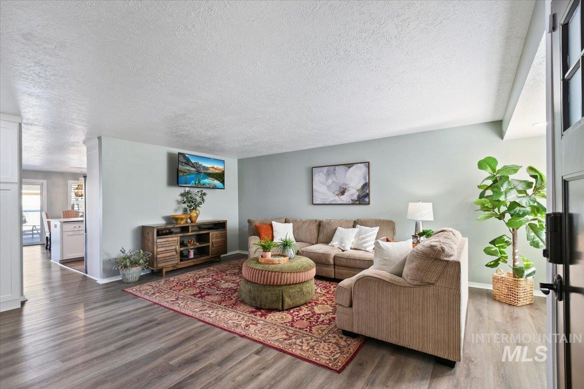 Living room featuring a textured ceiling and wood finished floors