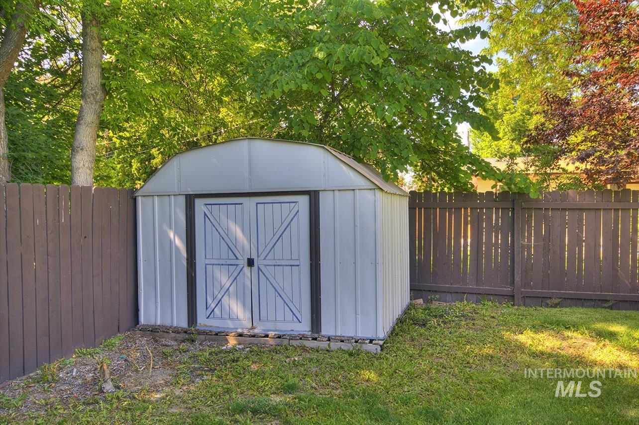 View of shed with a fenced backyard