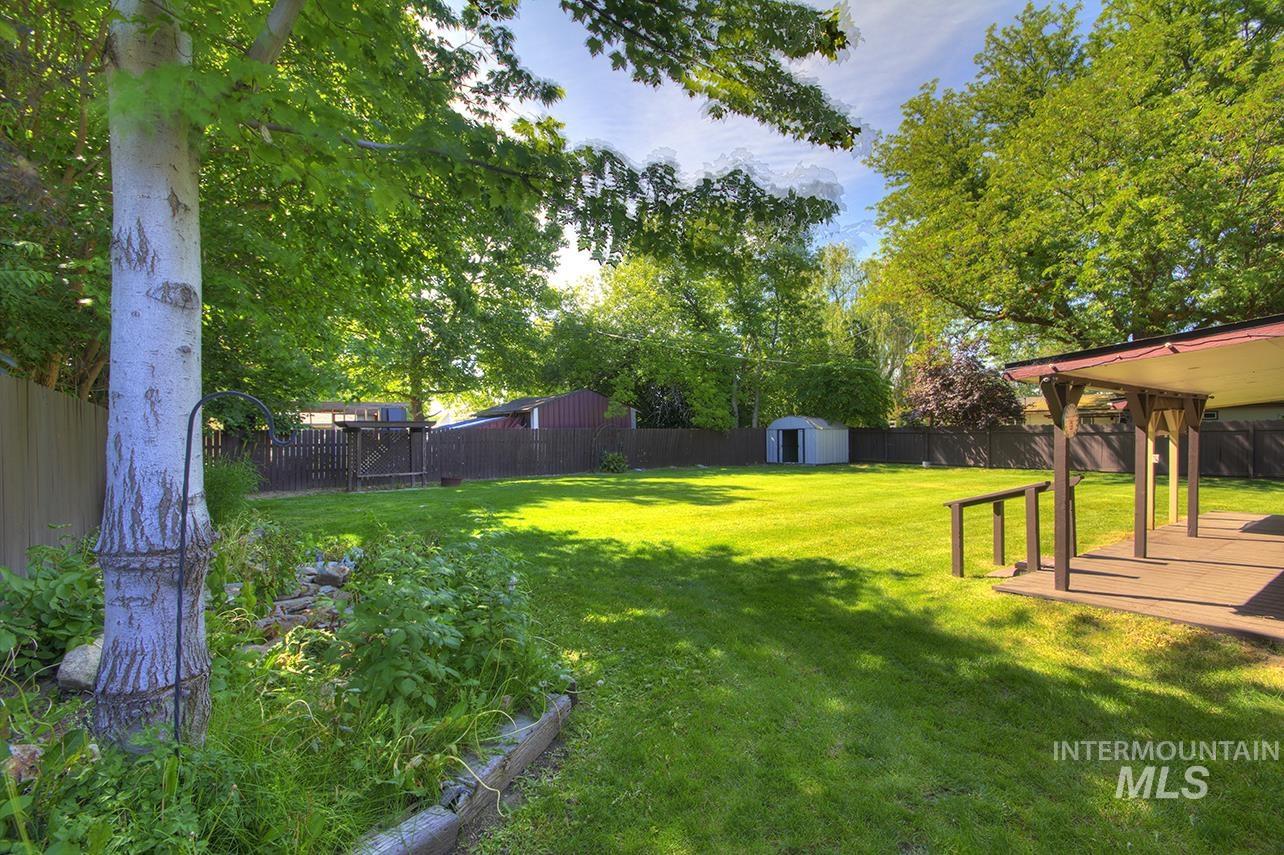 Fenced backyard with a storage shed