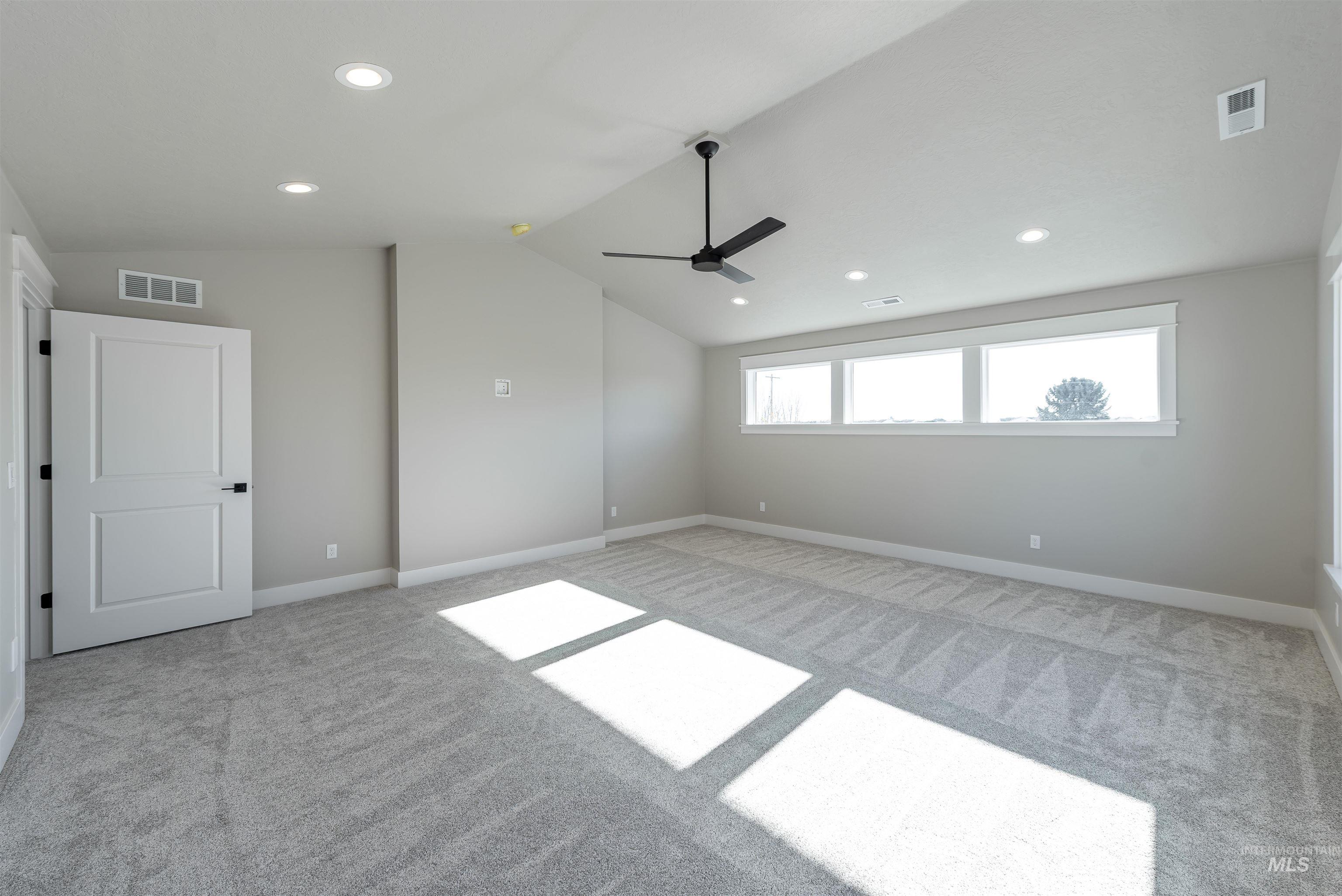 Spare room with vaulted ceiling, recessed lighting, light carpet, and a ceiling fan