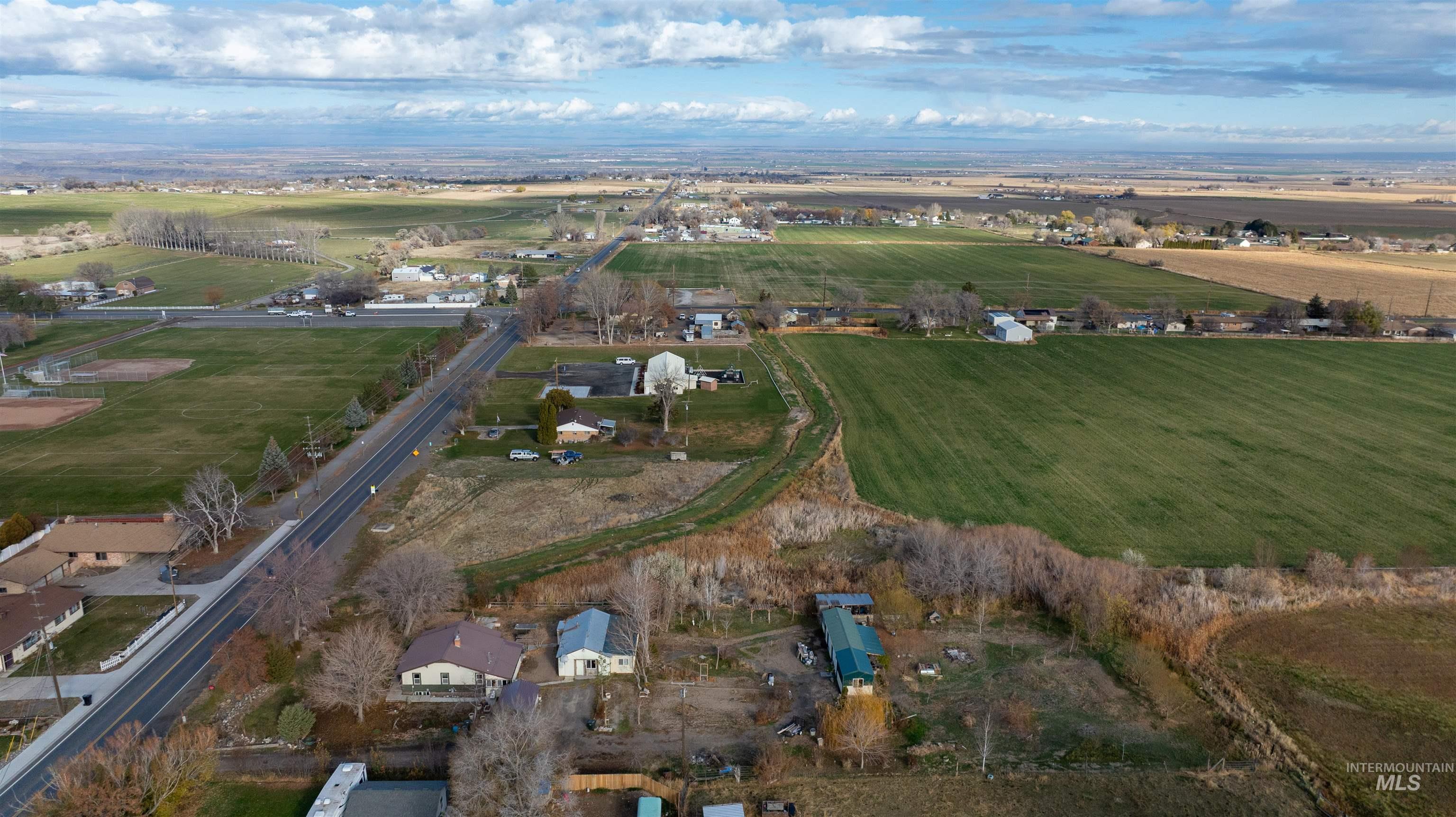 Aerial view of property's location featuring rural landscape and farmland