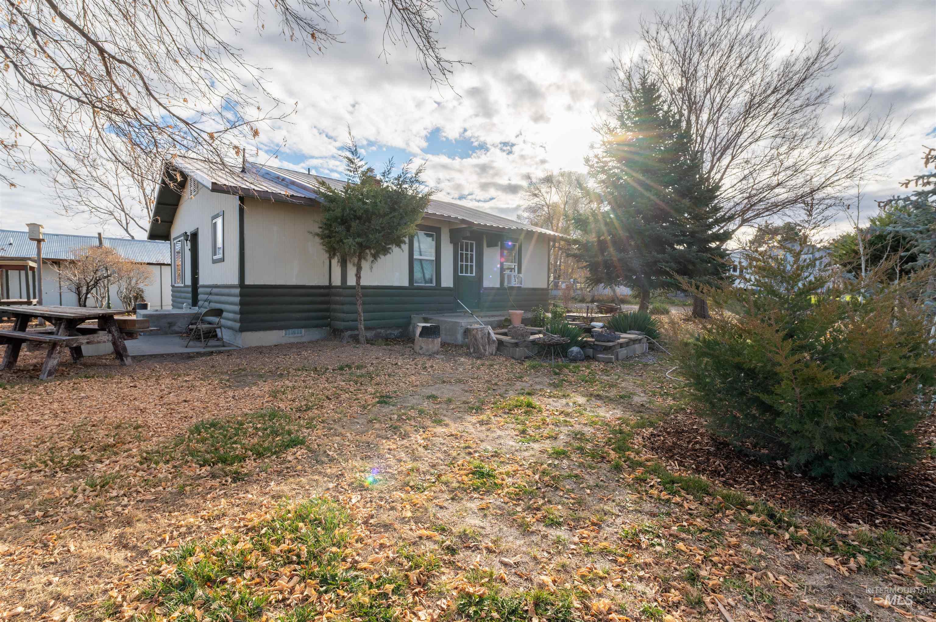 View of property exterior with crawl space, a metal roof, and a patio area