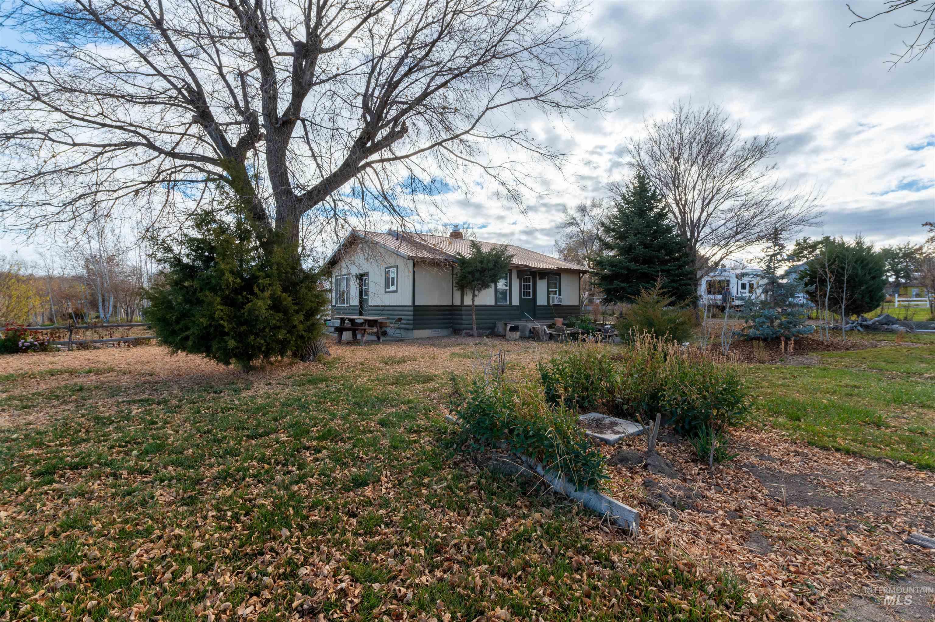 Back of property with a lawn