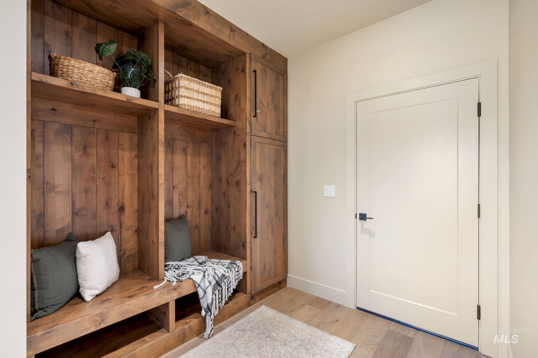 Mudroom featuring light wood-type flooring and baseboards