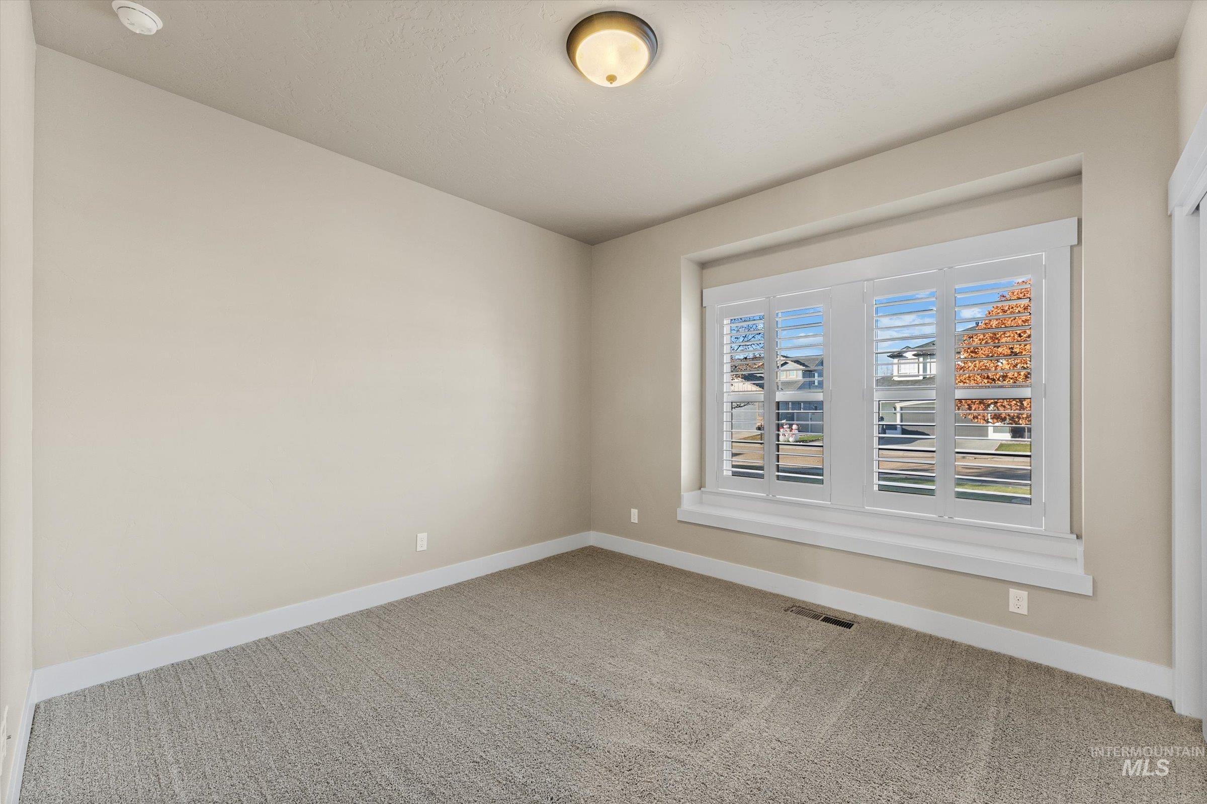 Unfurnished room with baseboards and carpet