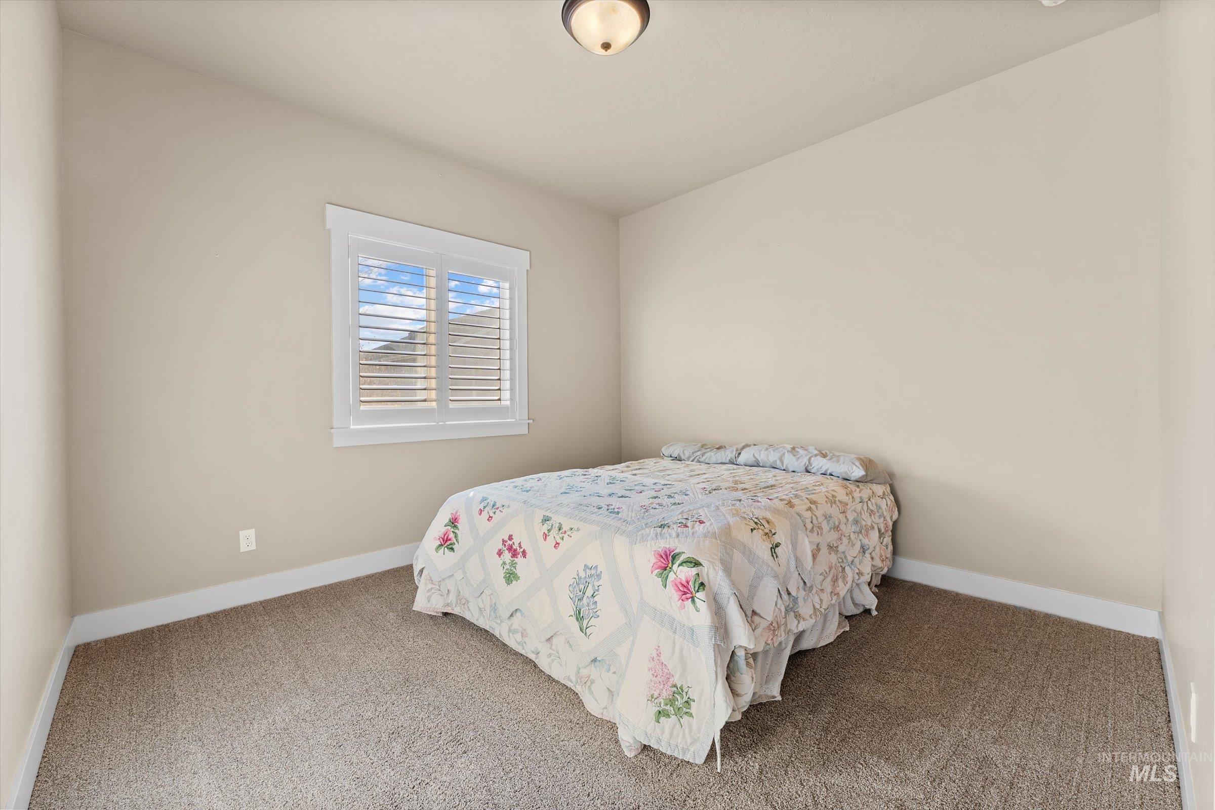 Carpeted bedroom featuring baseboards