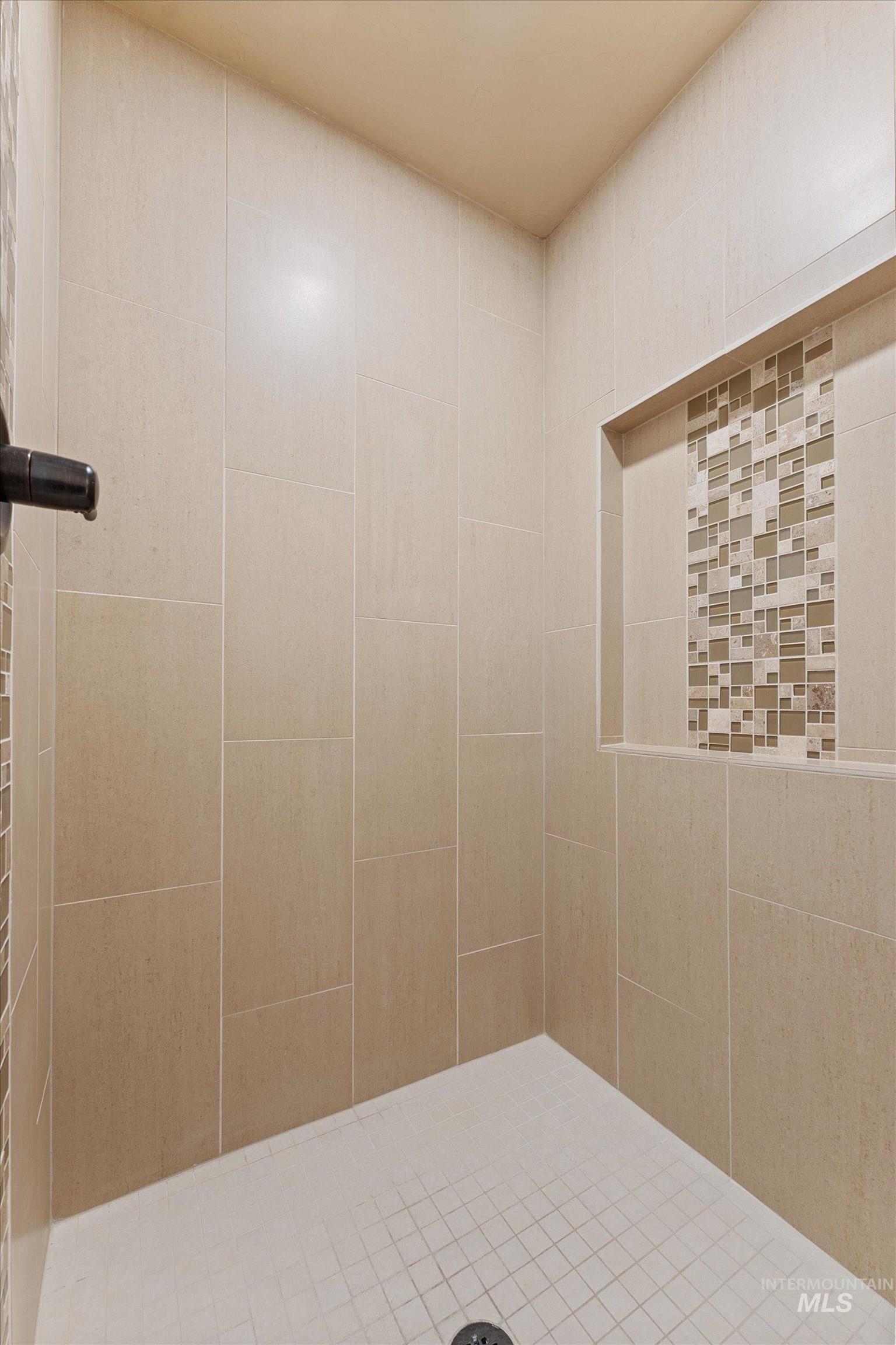 Full bath with a tile shower