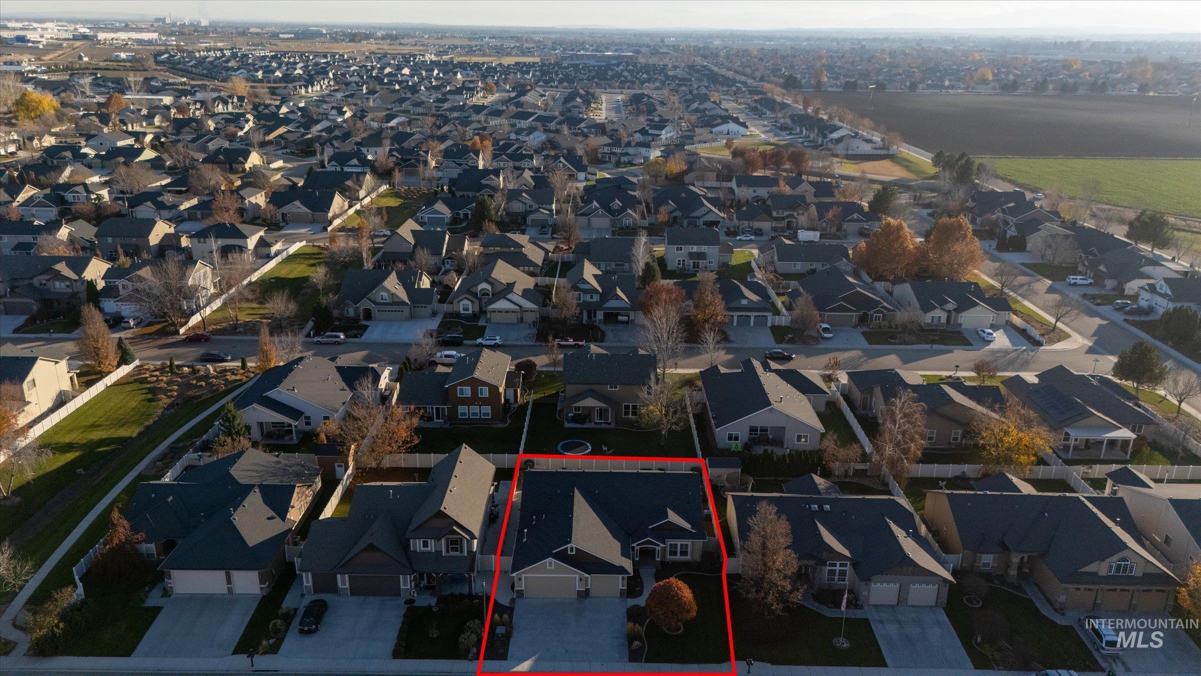 Aerial view of residential area featuring property boundaries highlighted