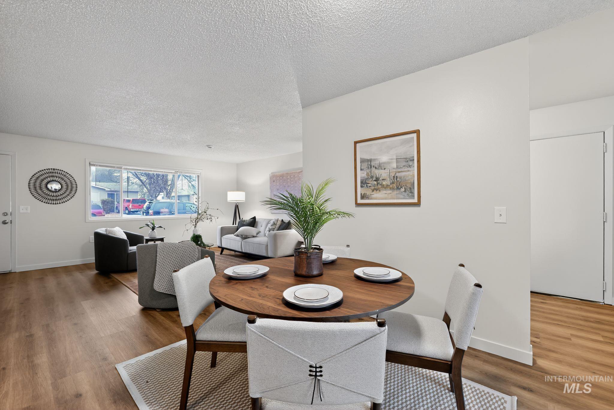 Dining room featuring wood finished floors and a textured ceiling