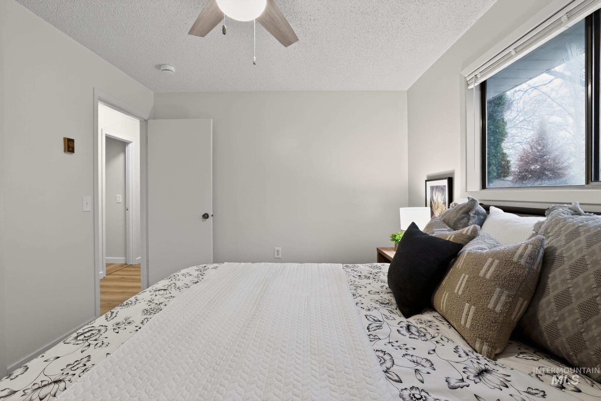 Bedroom featuring a textured ceiling and a ceiling fan