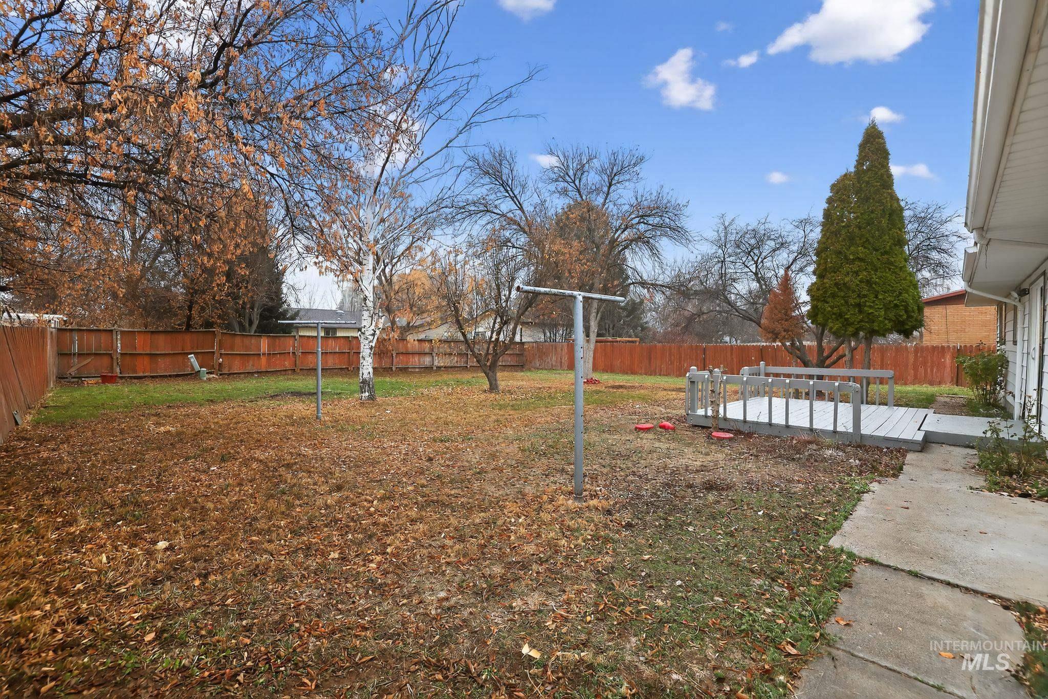 Fenced backyard with a wooden deck