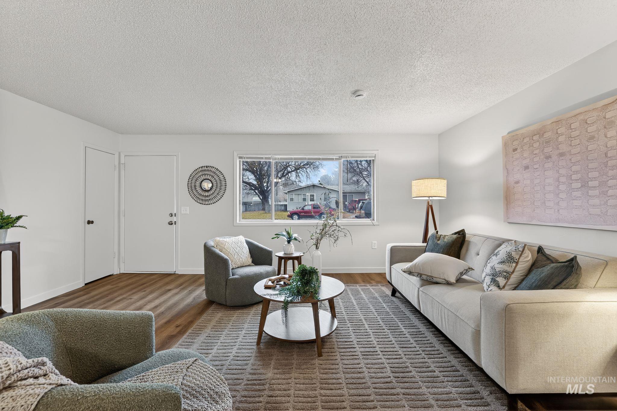 Living area with a textured ceiling and wood finished floors