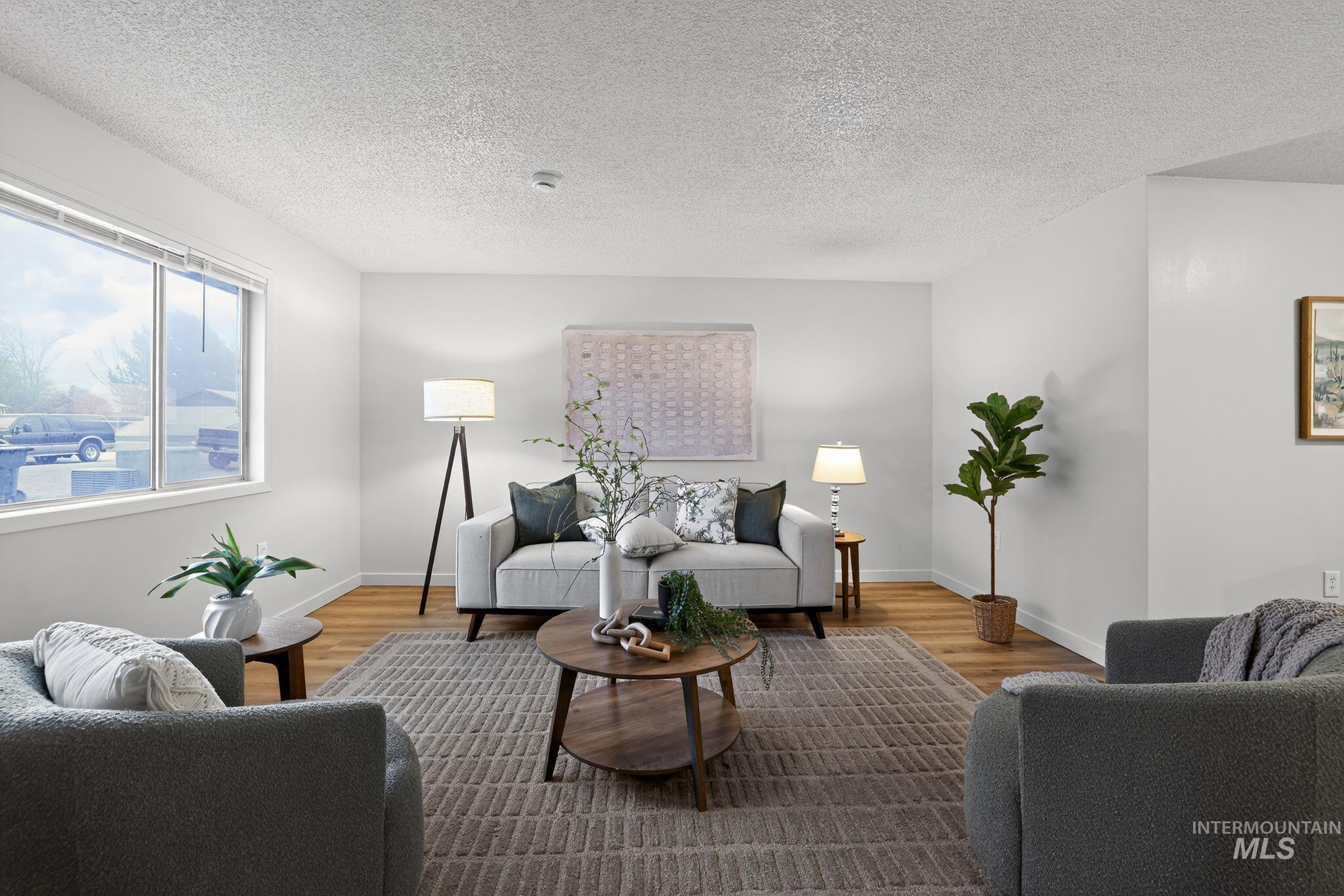 Living area with a textured ceiling and wood finished floors