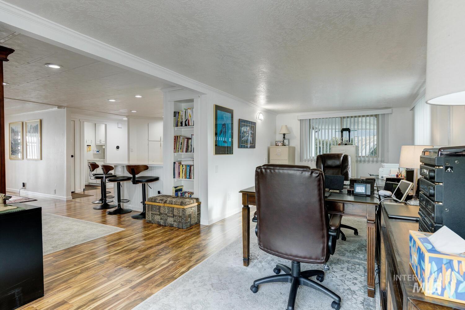 Office featuring a textured ceiling, wood finished floors, and recessed lighting