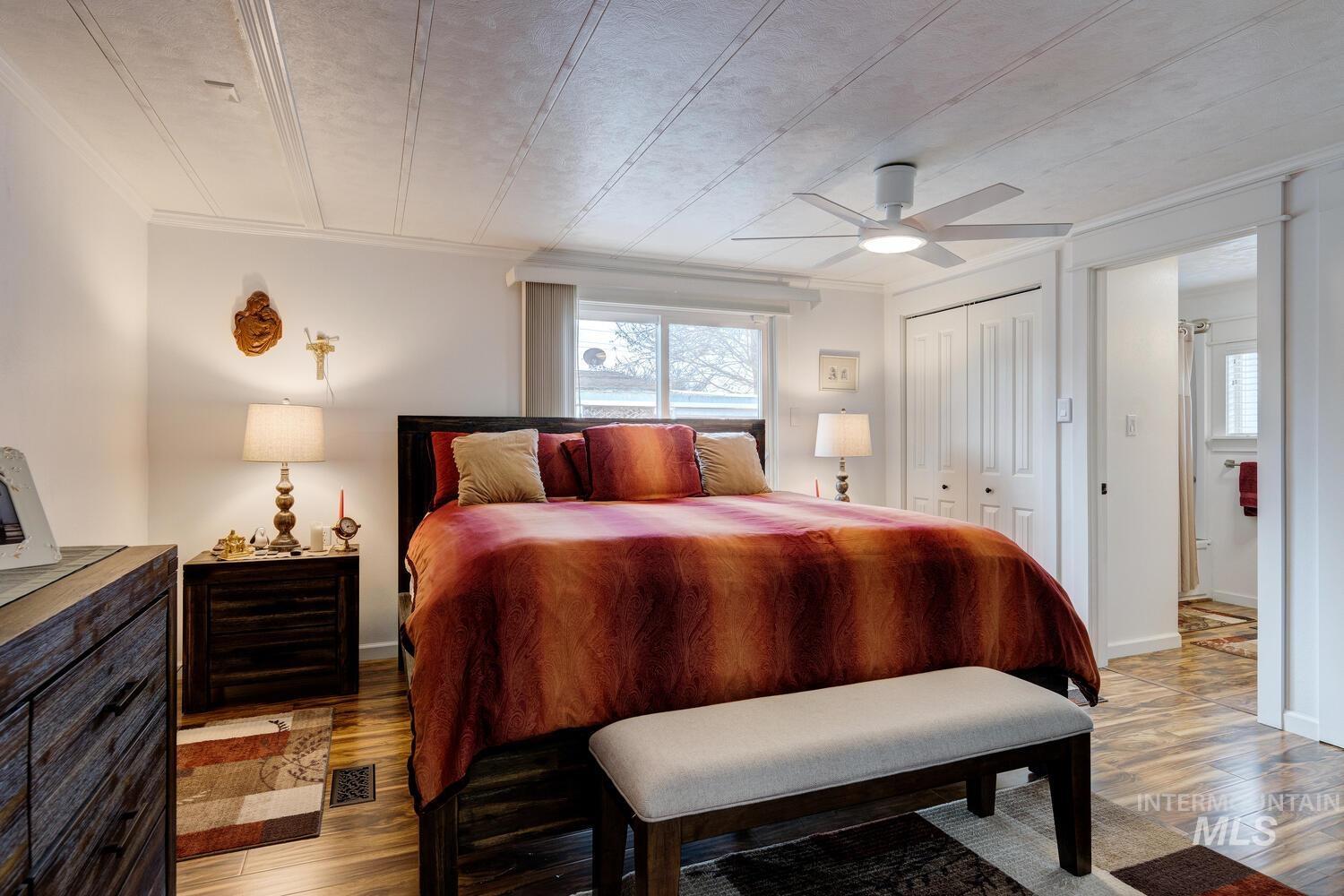 Bedroom featuring a closet, light wood-style flooring, and a ceiling fan