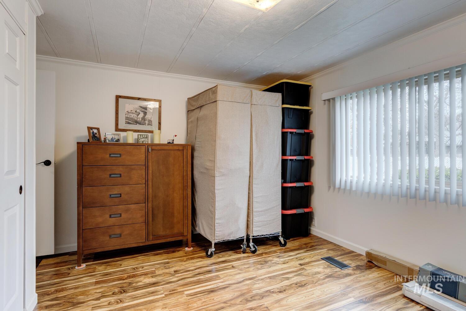 Bedroom featuring light wood-style flooring and a closet