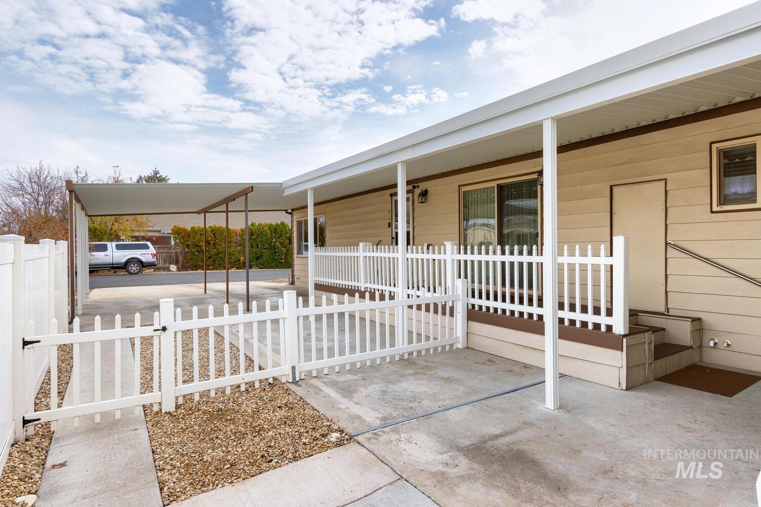 Porch featuring a gate and a carport