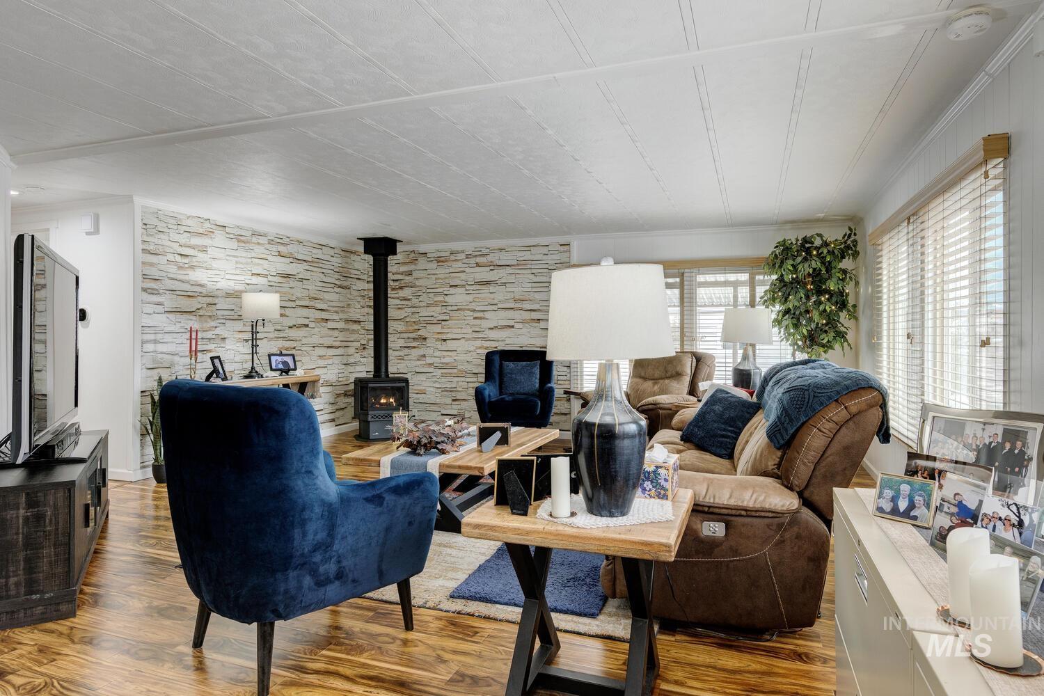 Living room featuring a wood stove and wood finished floors