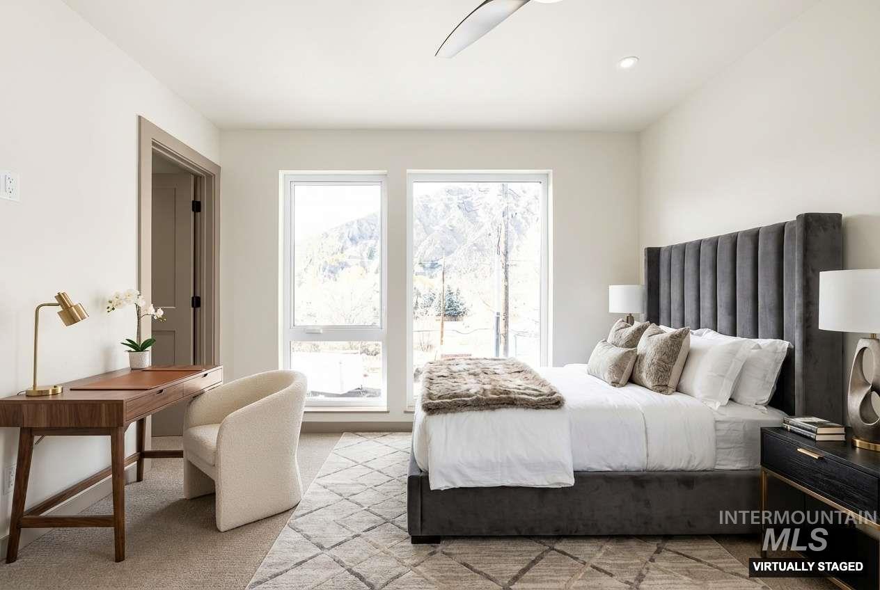 Bedroom with light carpet and ceiling fan