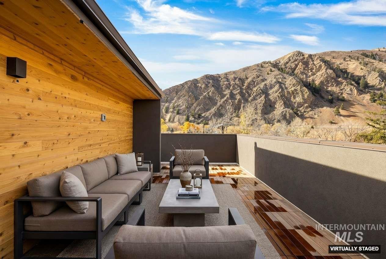 View of patio / terrace featuring a mountain view and an outdoor living space with a fire pit
