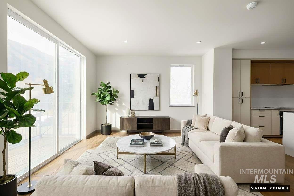 Living room featuring light wood finished floors and recessed lighting