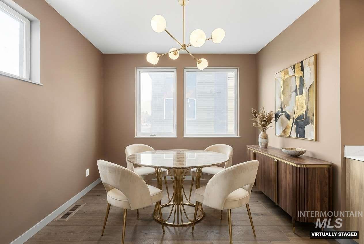 Dining room featuring light wood finished floors and a chandelier