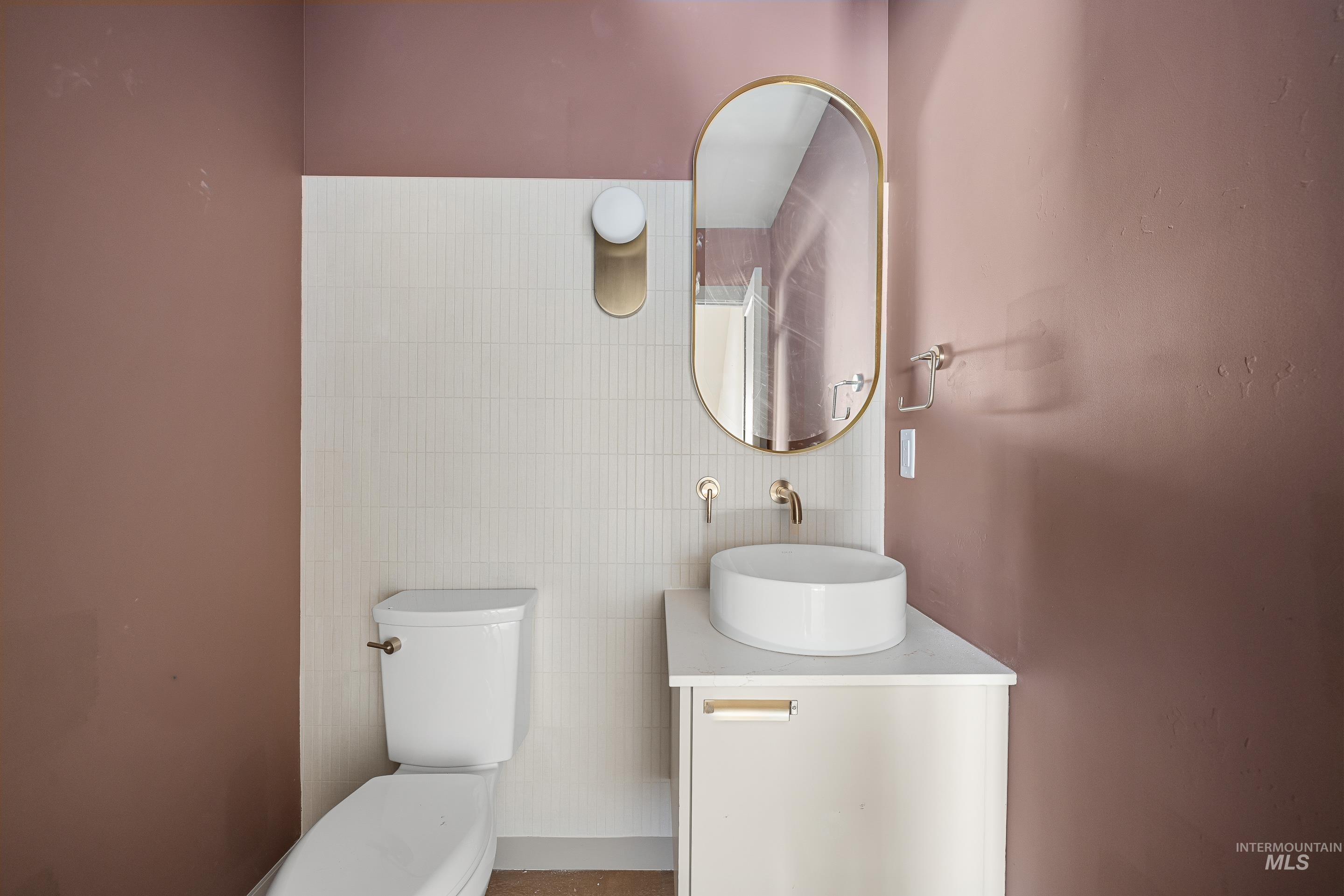 Bathroom featuring vanity and tile walls