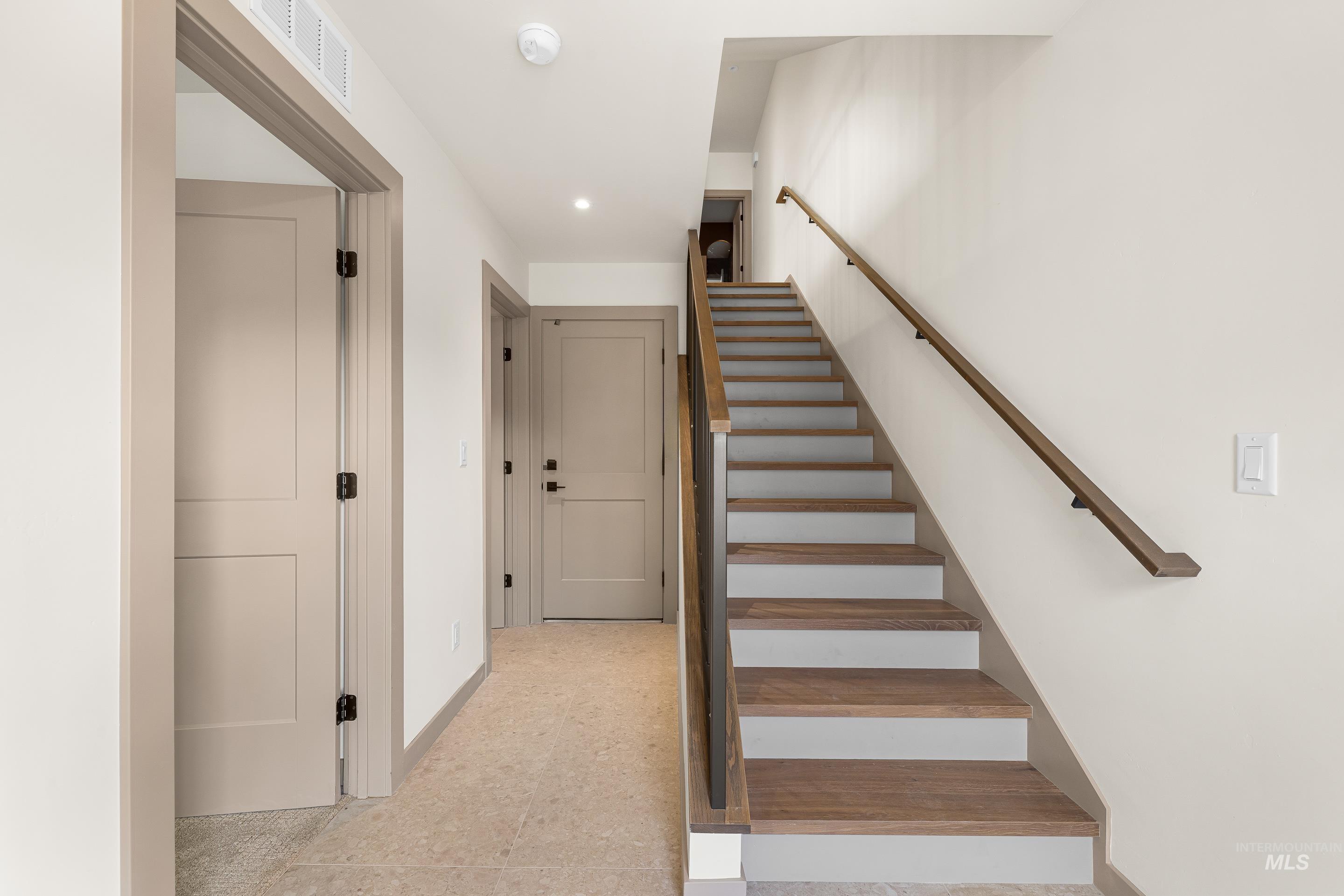 Stairs with baseboards and recessed lighting