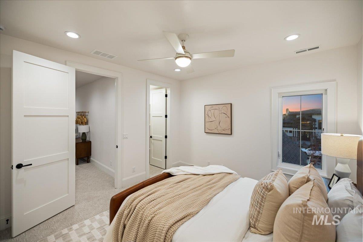 Bedroom featuring light carpet, recessed lighting, and a ceiling fan