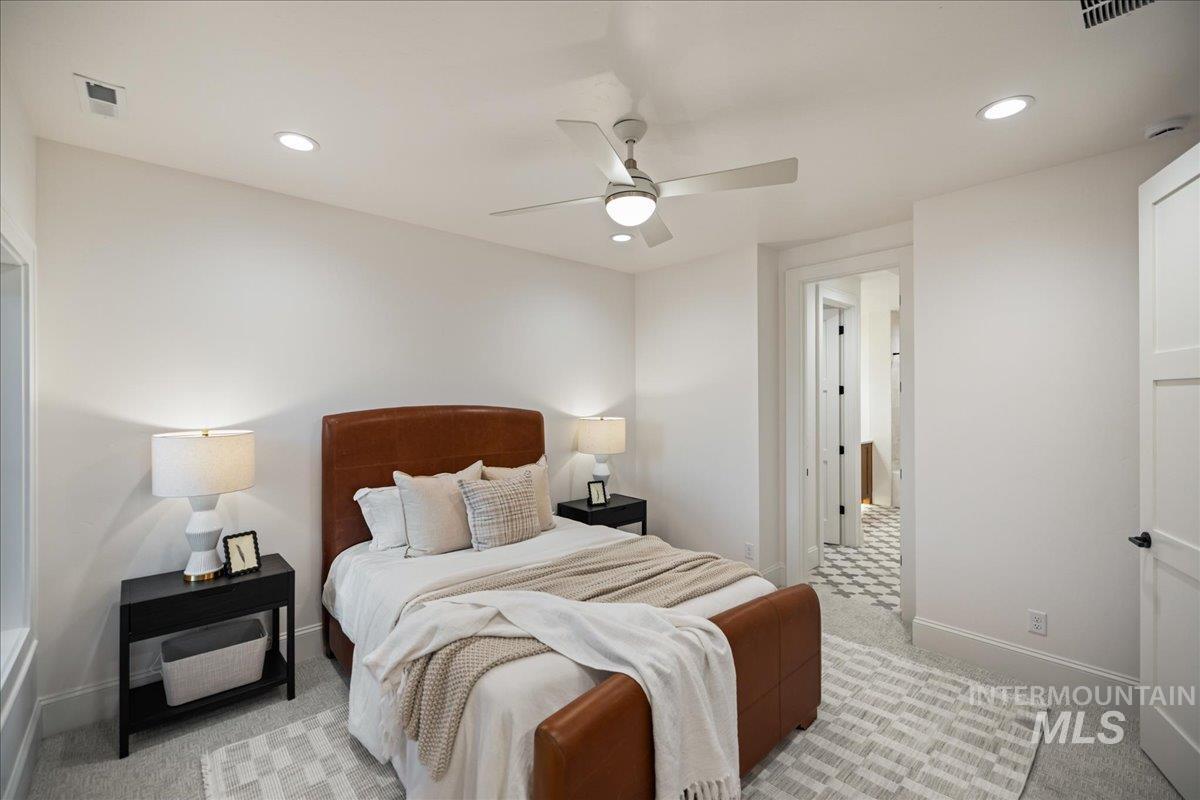 Bedroom with light colored carpet, recessed lighting, and a ceiling fan