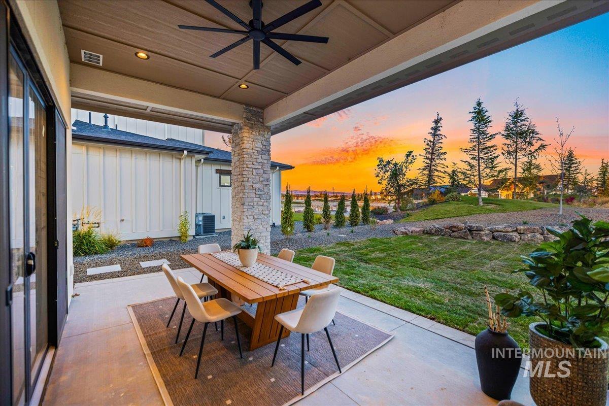 View of patio with a ceiling fan and outdoor dining area