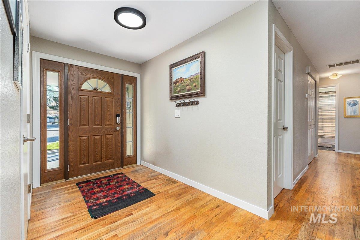 Entrance foyer with light wood-style flooring