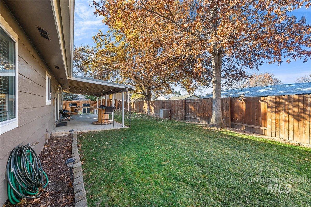 Fenced backyard with a patio