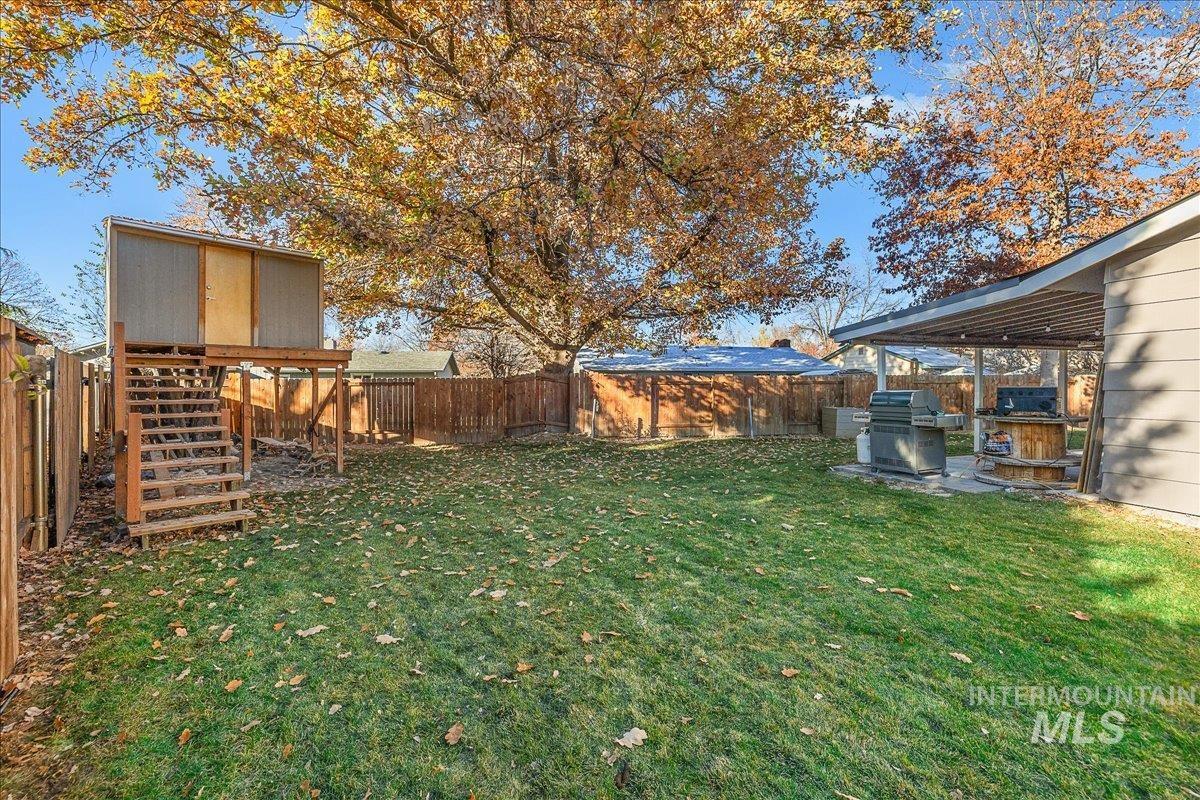 Fenced backyard with a patio